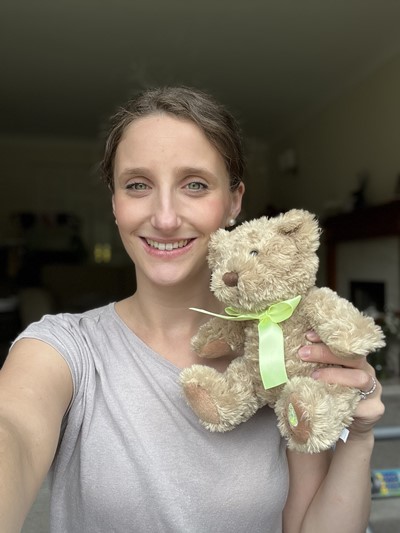 Our volunteer Christine, holding one of Aching Arms Comfort Bears