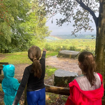 Children who attended our family Teddy Bears Picnic looking forward at the rainbow over the Forest